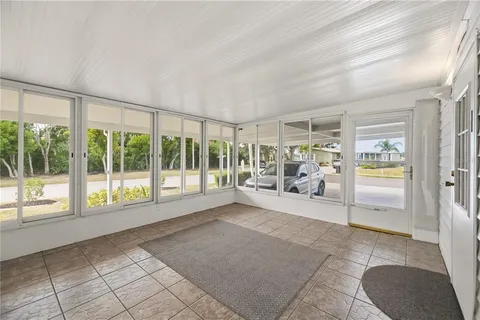 a view of a livingroom with wooden floor and a ceiling fan