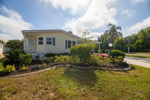an aerial view of a house with outdoor space and lake view