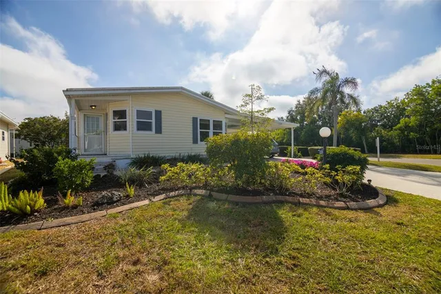 an aerial view of a house with outdoor space and lake view