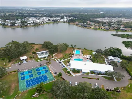 an aerial view of a house with yard lake and mountain view