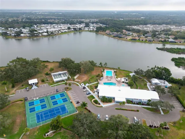 an aerial view of a house with yard lake and mountain view