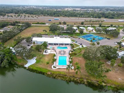 a view of a swimming pool with a patio and a yard
