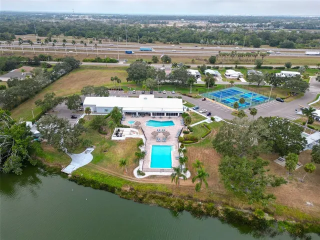 a view of a swimming pool with a patio and a yard