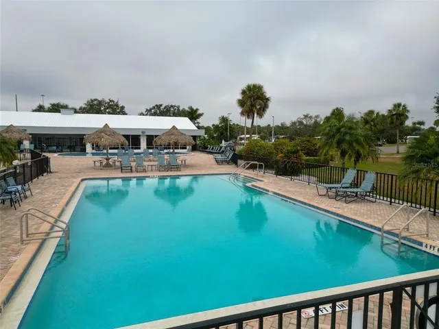 an aerial view of a house with pool yard and outdoor seating
