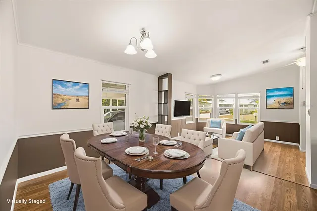 a view of a dining room with furniture and wooden floor