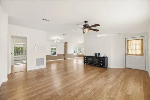 a view of empty room with wooden floor and fireplace
