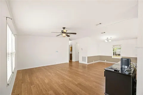 a view of a kitchen with a sink and cabinet with wooden floor