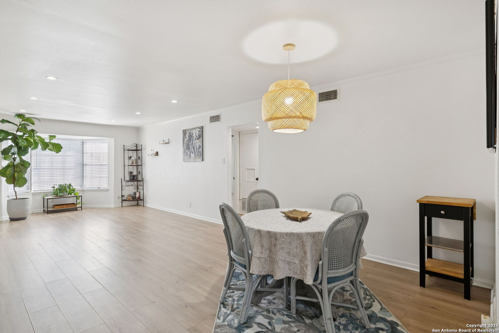 102 Ruelle Lane, Unit 220B San Antonio, TX 78209 - Photo 16 of 37 a view of a dining room with furniture and wooden floor