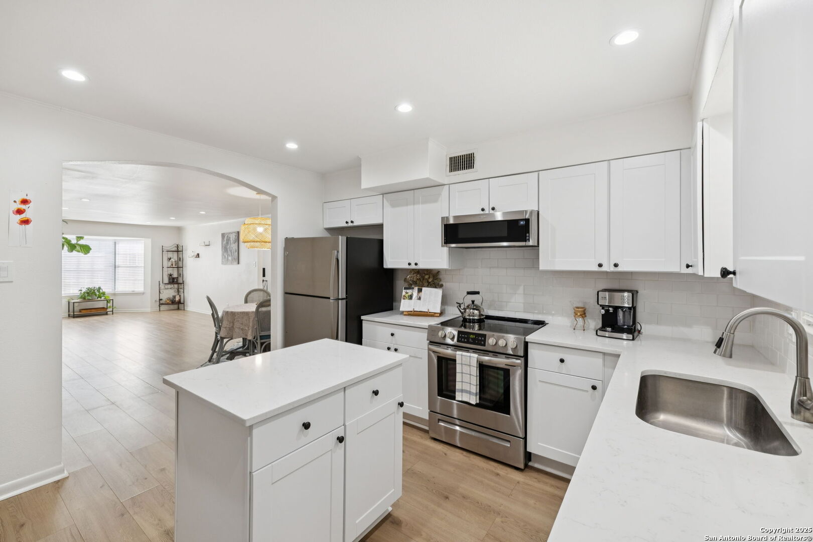 102 Ruelle Lane, Unit 220B San Antonio, TX 78209 - Photo 19 of 37 a kitchen with a sink white cabinets and stainless steel appliances