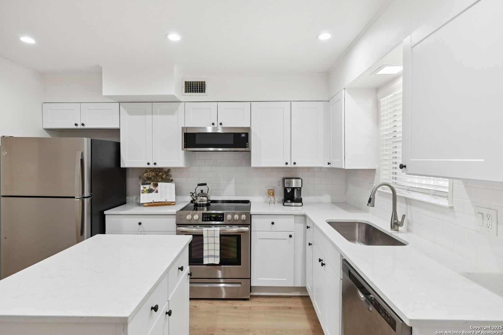 102 Ruelle Lane, Unit 220B San Antonio, TX 78209 - Photo 20 of 37 a kitchen with a sink a stove and refrigerator