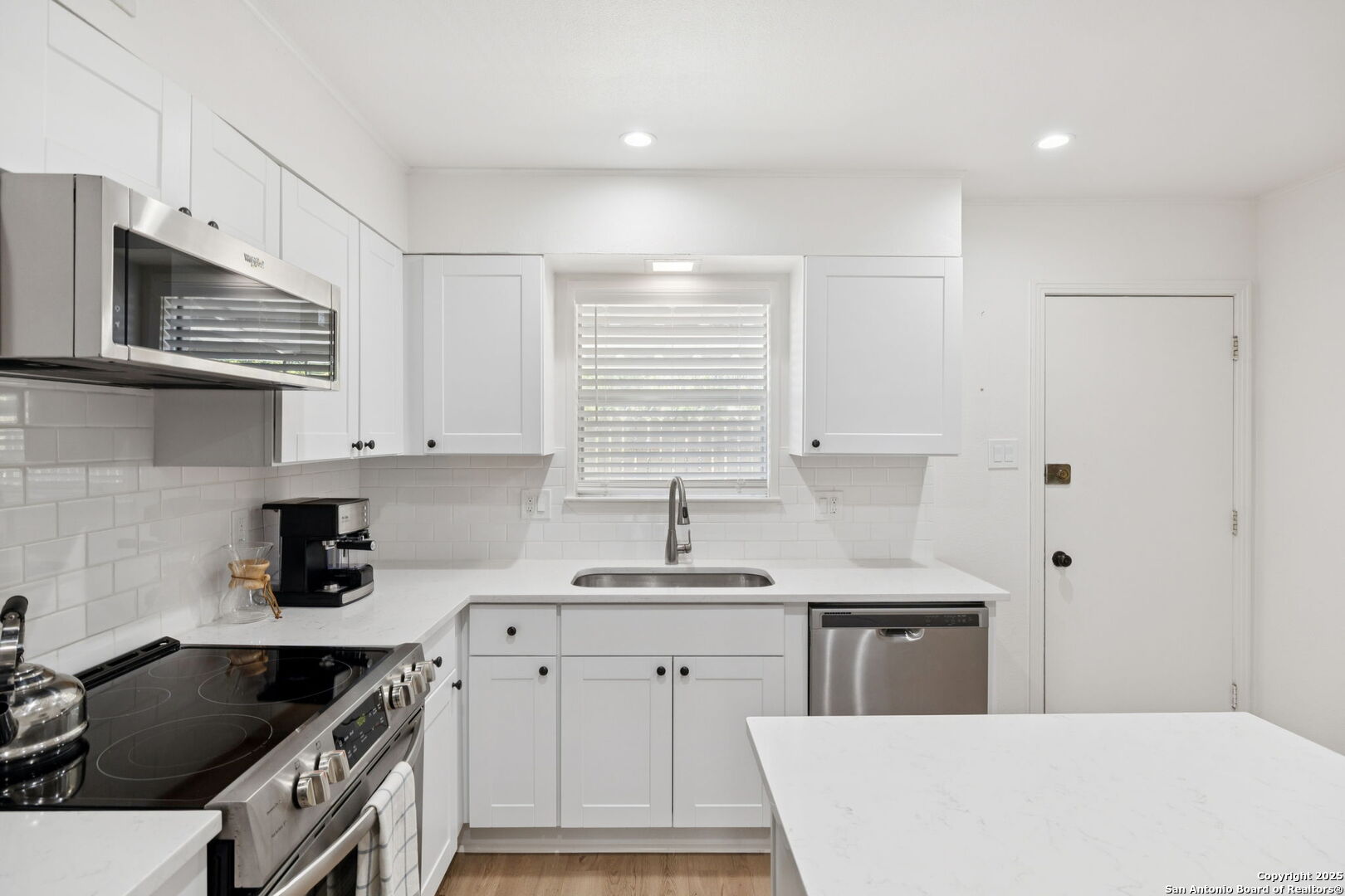 102 Ruelle Lane, Unit 220B San Antonio, TX 78209 - Photo 21 of 37 a kitchen with stainless steel appliances a sink stove and cabinets