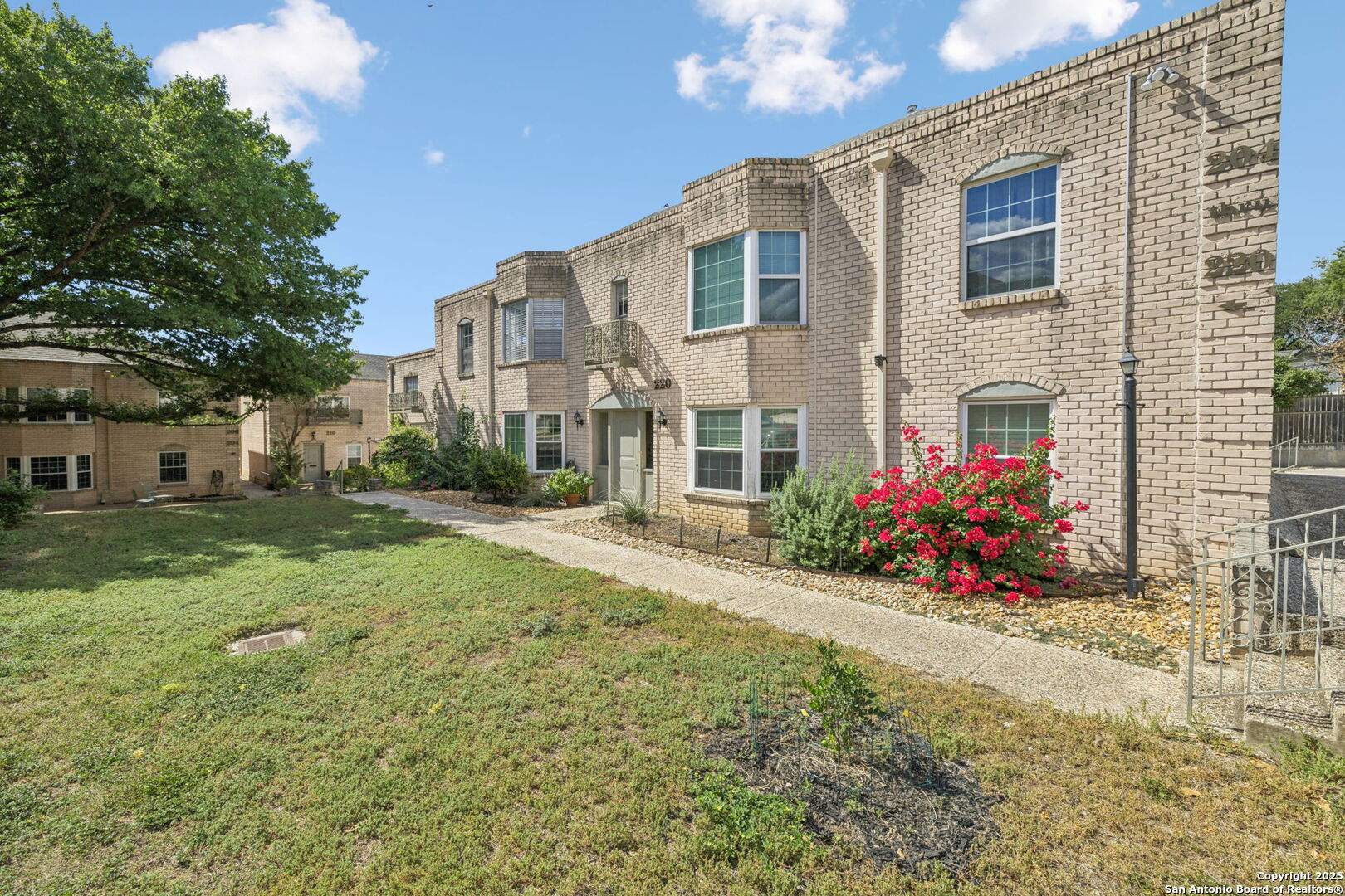 102 Ruelle Lane, Unit 220B San Antonio, TX 78209 - Photo 3 of 37 a view of a house with a yard