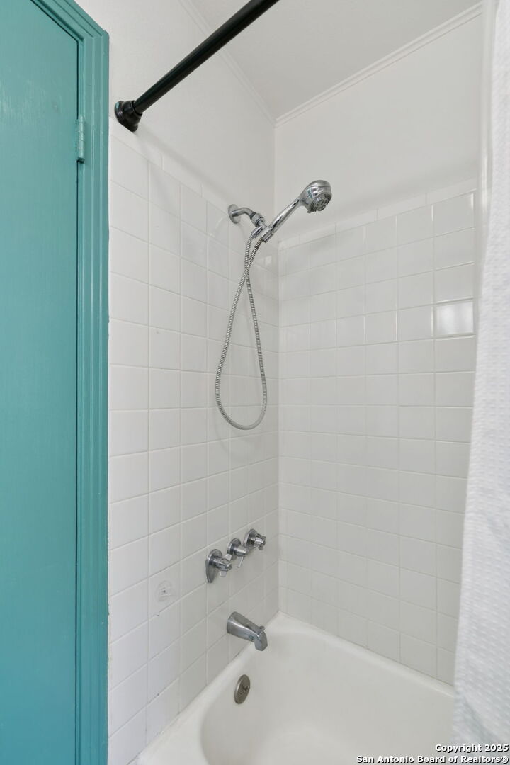 102 Ruelle Lane, Unit 220B San Antonio, TX 78209 - Photo 31 of 37 a bathroom with a bath tub with a shower