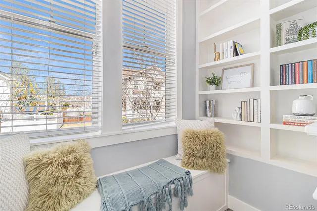 a living room with furniture a table and a large window