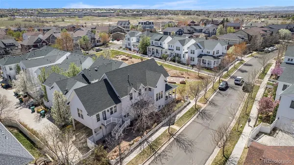 an aerial view of a house with a mountain