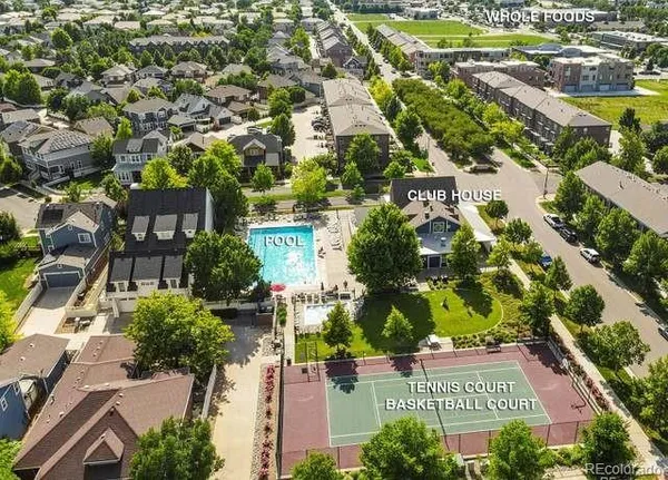 an aerial view of residential houses with outdoor space and street view