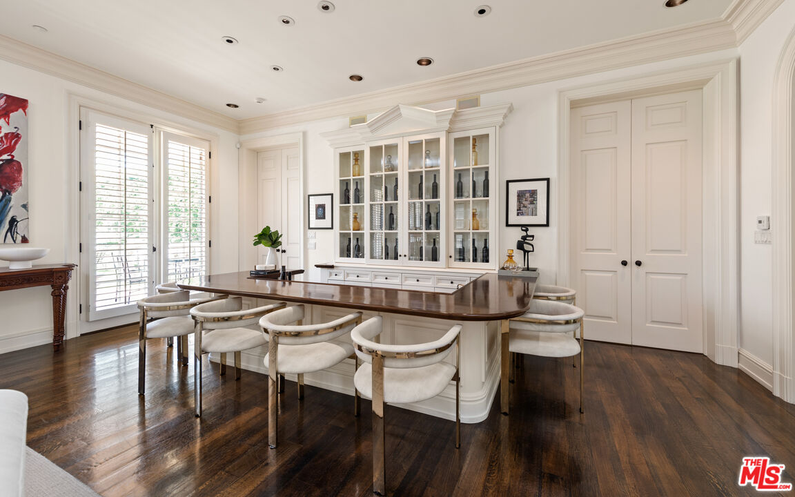 805 North Alpine Drive Beverly Hills, CA 90210 - Photo 14 of 48 a dining room with wooden floor and large windows