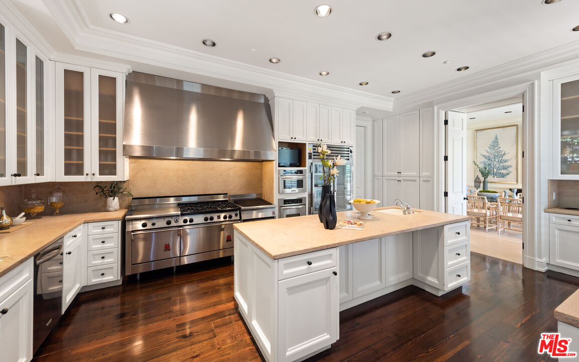 805 North Alpine Drive Beverly Hills, CA 90210 - Photo 17 of 48 a kitchen with stainless steel appliances granite countertop hardwood floor sink stove and wooden floor