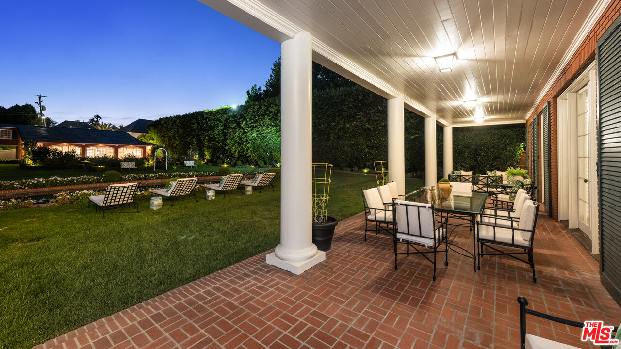805 North Alpine Drive Beverly Hills, CA 90210 - Photo 21 of 48 a view of a patio with a table chairs and a patio