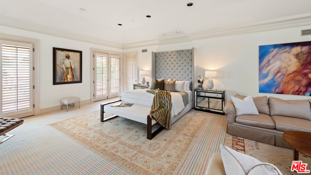 805 North Alpine Drive Beverly Hills, CA 90210 - Photo 23 of 48 a spacious bedroom with a bed and couch
