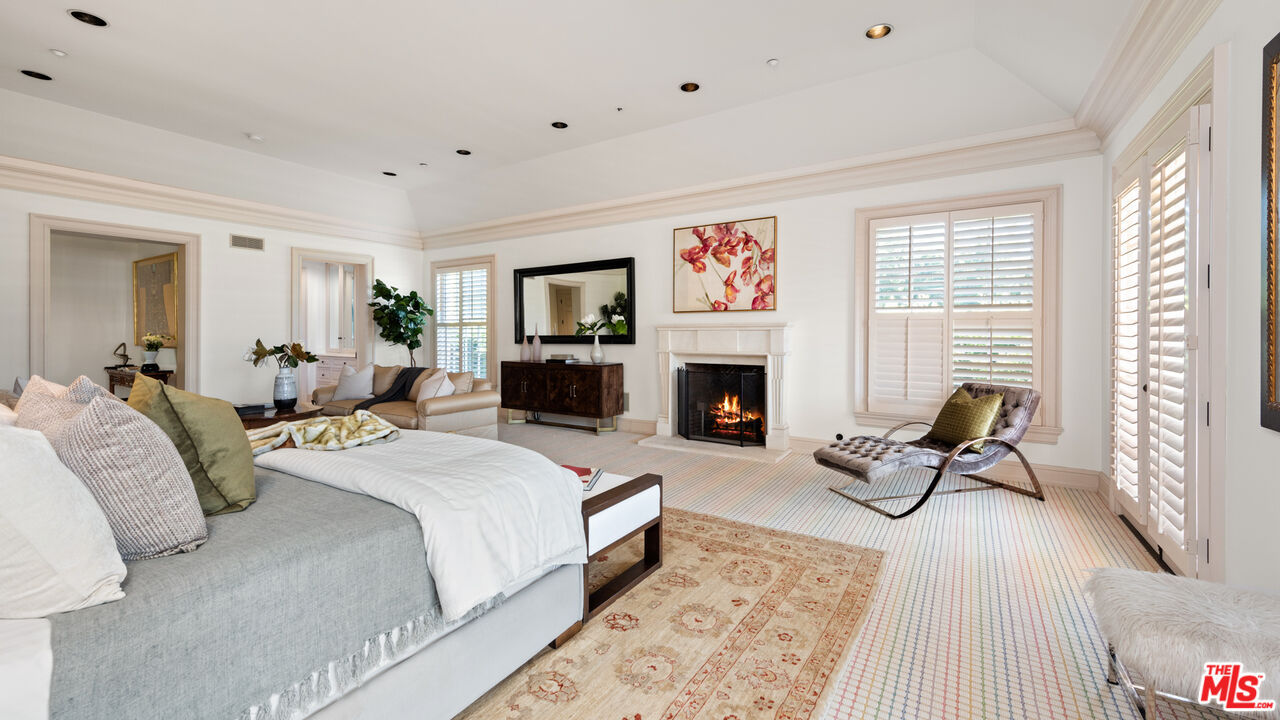 805 North Alpine Drive Beverly Hills, CA 90210 - Photo 25 of 48 a bed room with furniture and a fireplace