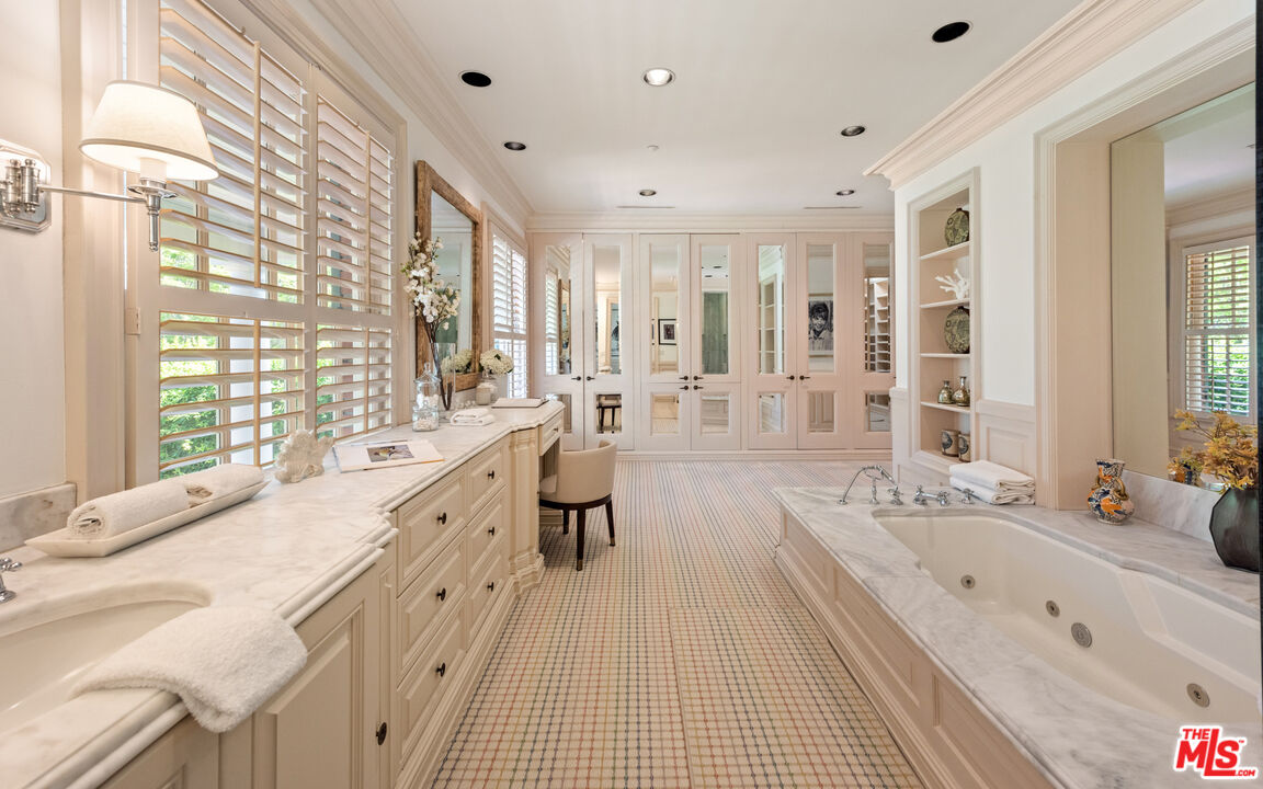 805 North Alpine Drive Beverly Hills, CA 90210 - Photo 31 of 48 a large white bathroom with a large tub sink and window