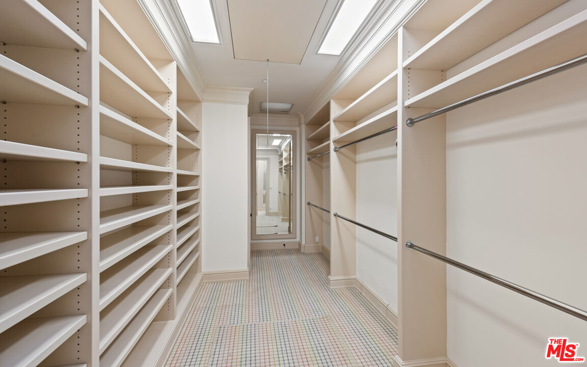 805 North Alpine Drive Beverly Hills, CA 90210 - Photo 32 of 48 a view of walk in closet with empty racks