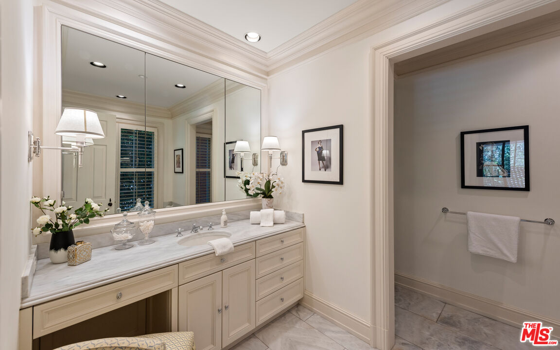 805 North Alpine Drive Beverly Hills, CA 90210 - Photo 36 of 48 a bathroom with a double vanity sink and a mirror