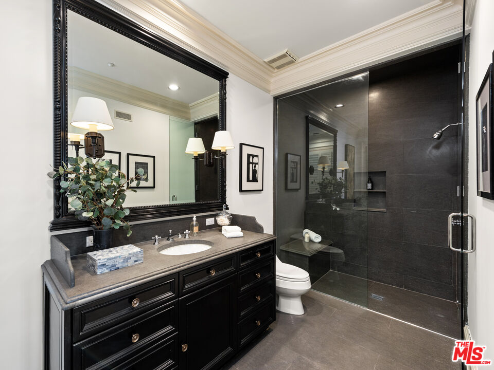 805 North Alpine Drive Beverly Hills, CA 90210 - Photo 38 of 48 a bathroom with a double vanity sink toilet and shower
