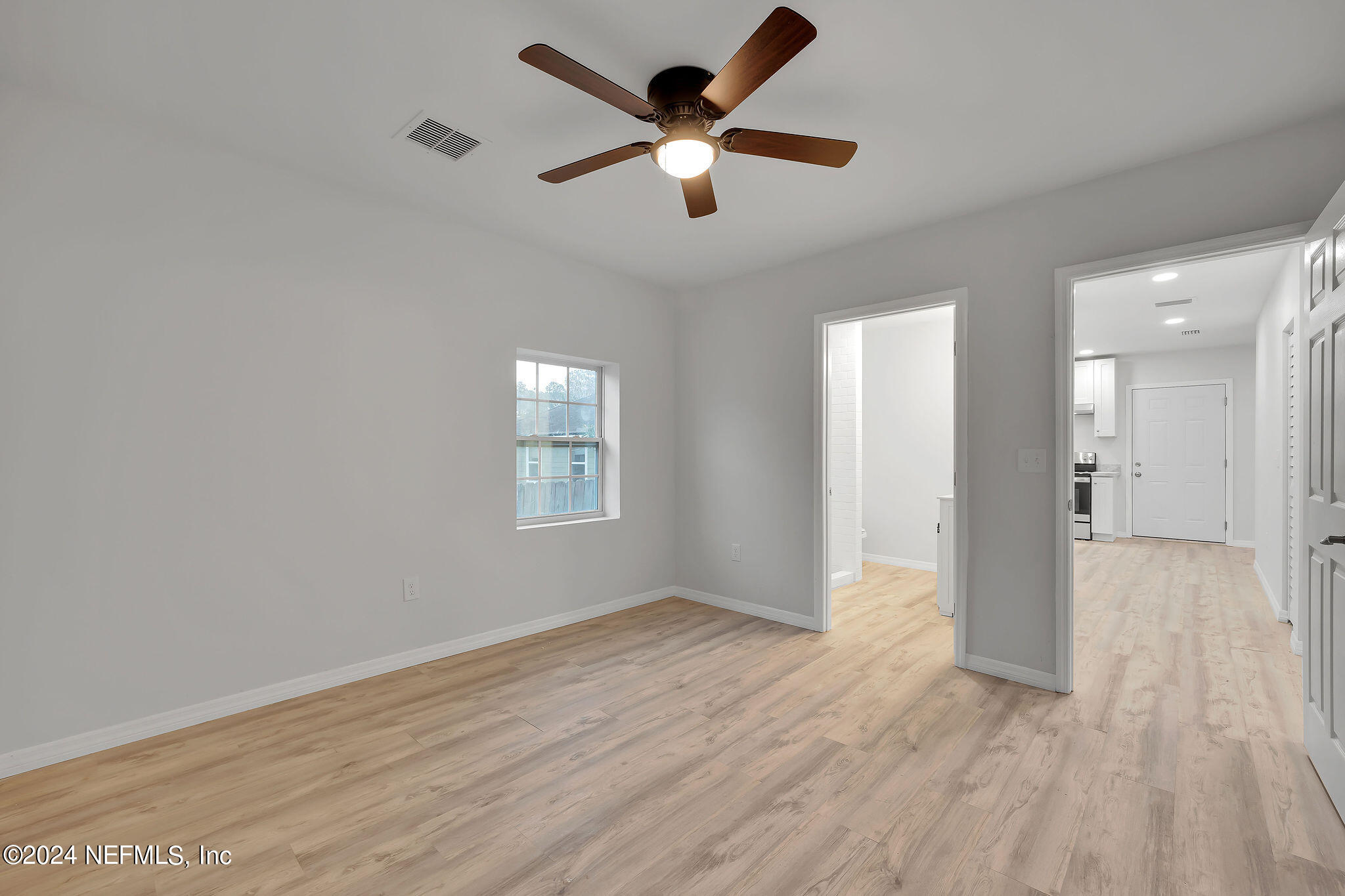 7519 Birdies Road Jacksonville, FL 32256 - Photo 17 of 24 wooden floor in an empty room with a window