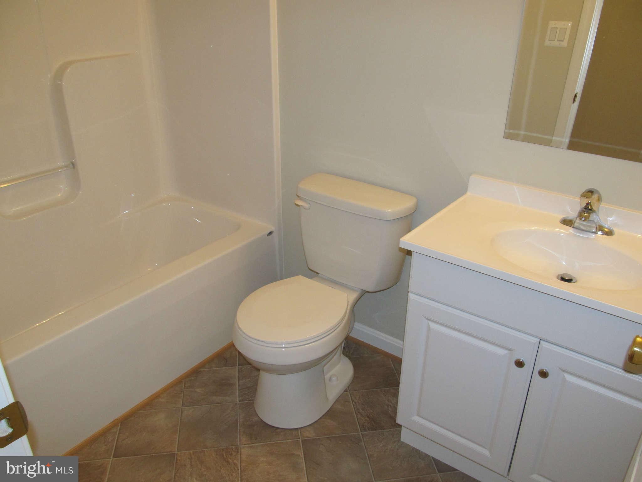 12554 Santa Rosa Road Lusby, MD 20657 - Photo 17 of 23 a white toilet sitting next to a bath tub