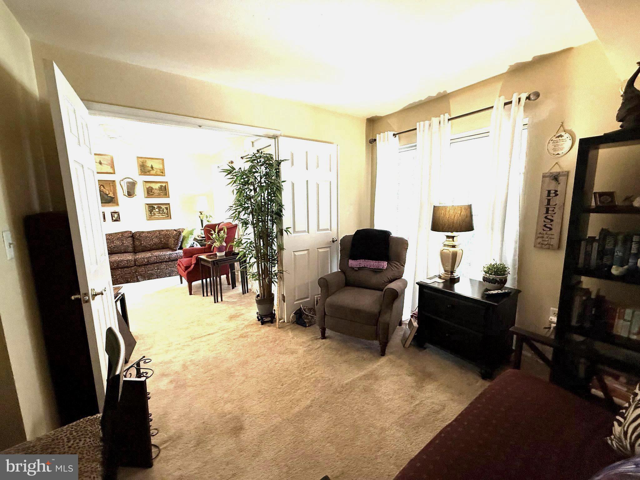302 Canterbury Road, Unit 302E Bel Air, MD 21014 - Photo 21 of 39 a living room with furniture a large window and storage
