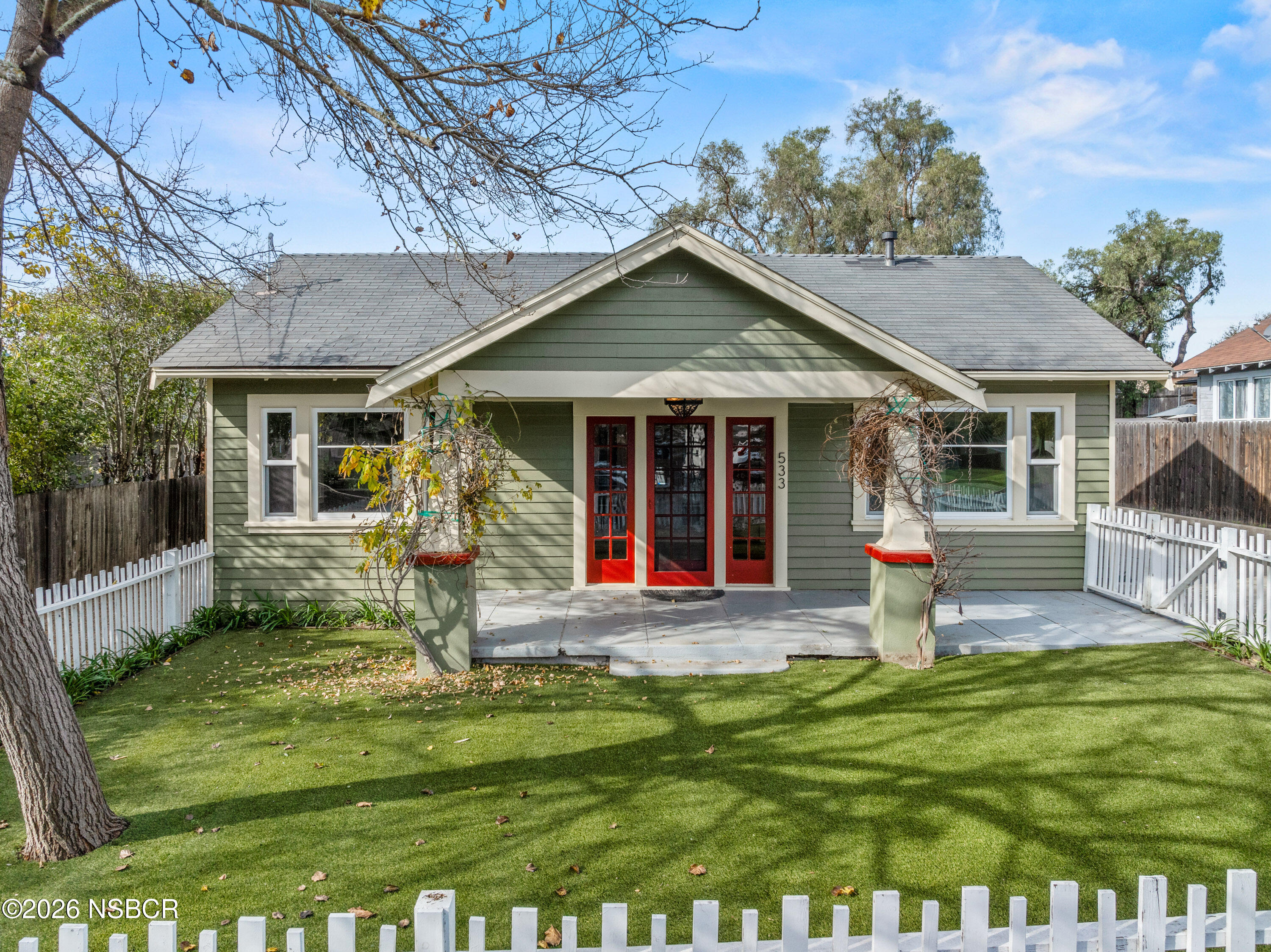 533 Pine Street Solvang, CA 93463 - Photo 2 of 37 a front view of a house with a yard table and chairs
