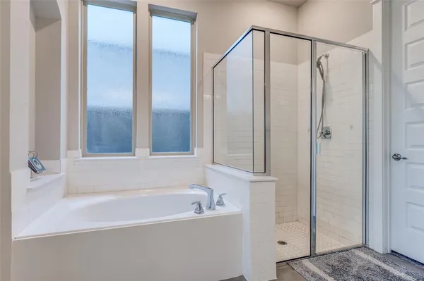 a bathroom with a bathtub and a shower