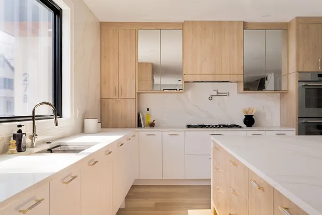 a kitchen with a sink cabinets and appliances
