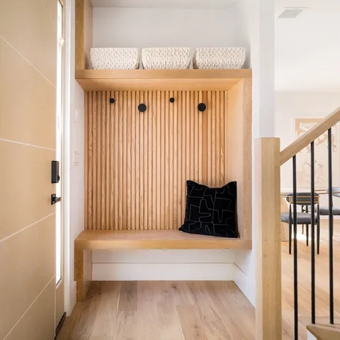a view of a bedroom with wooden floor and a window