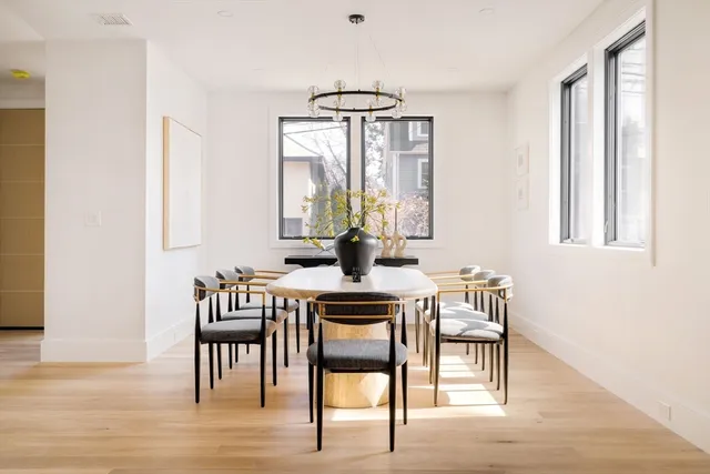 a dining room with furniture a chandelier and wooden floor