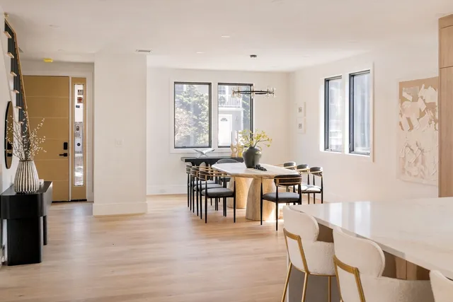 a view of a a dining room with furniture window and wooden floor