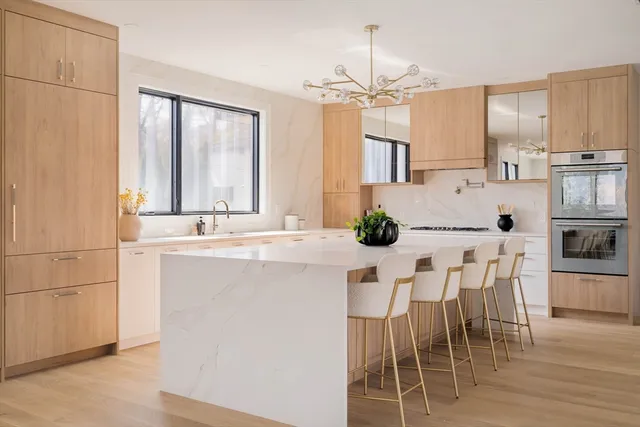 a kitchen with kitchen island granite countertop a table and chairs in it