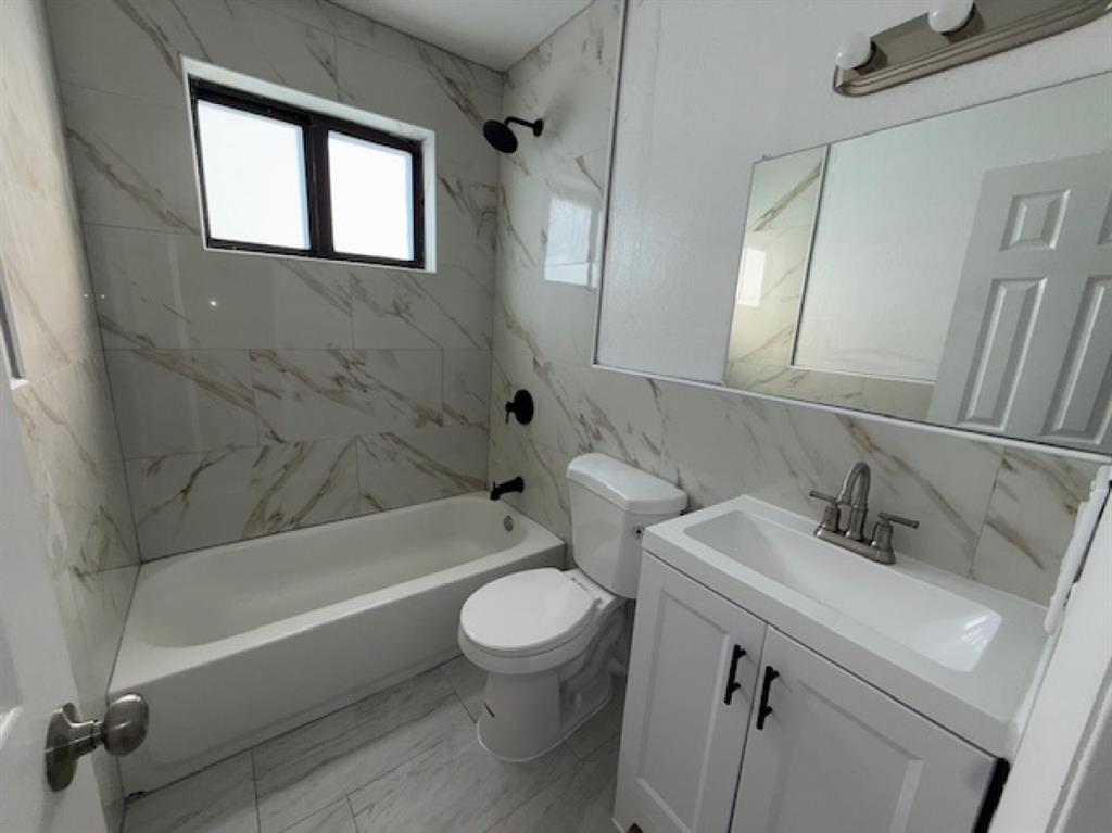 323 Northwest 4th Avenue, Unit R Hallandale Beach, FL 33009 - Photo 11 of 16 a bathroom with a sink toilet and bathtub