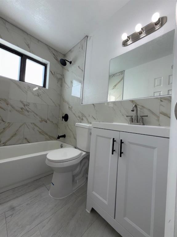 323 Northwest 4th Avenue, Unit R Hallandale Beach, FL 33009 - Photo 12 of 16 a bathroom with a sink mirror vanity and toilet