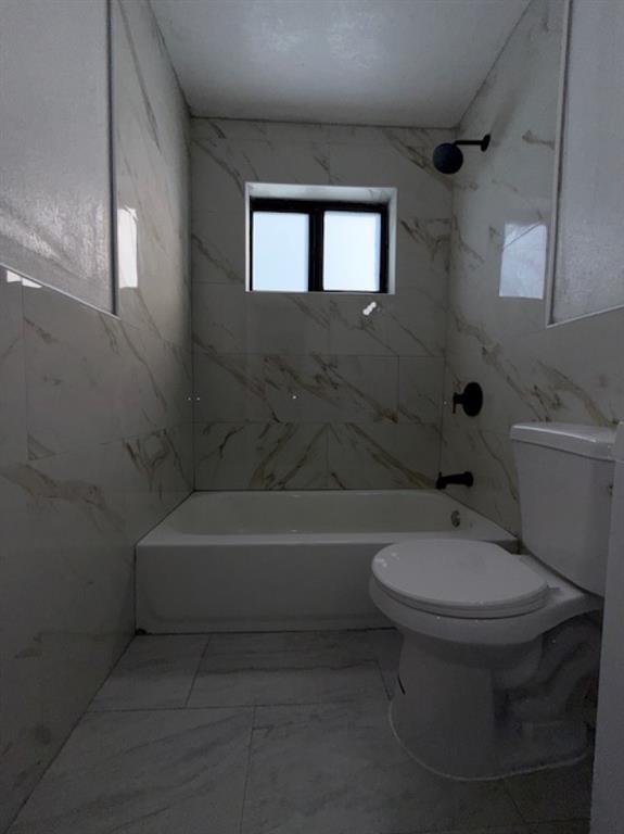 323 Northwest 4th Avenue, Unit R Hallandale Beach, FL 33009 - Photo 13 of 16 a bathroom with a sink a toilet and bathtub