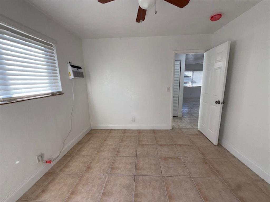 323 Northwest 4th Avenue, Unit R Hallandale Beach, FL 33009 - Photo 14 of 16 wooden floor in an empty room with a window
