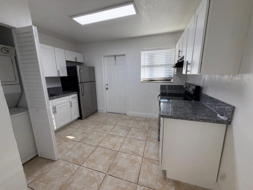 323 Northwest 4th Avenue, Unit R Hallandale Beach, FL 33009 - Photo 3 of 16 a kitchen with stainless steel appliances granite countertop a sink stove and refrigerator
