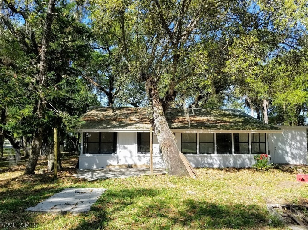 1343 Ortona Locks Road Moore Haven, FL 33471 - Photo 2 of 7 a front view of a house with a yard