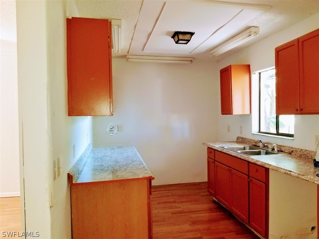 1343 Ortona Locks Road Moore Haven, FL 33471 - Photo 5 of 7 a kitchen with stainless steel appliances granite countertop a sink stove and cabinets