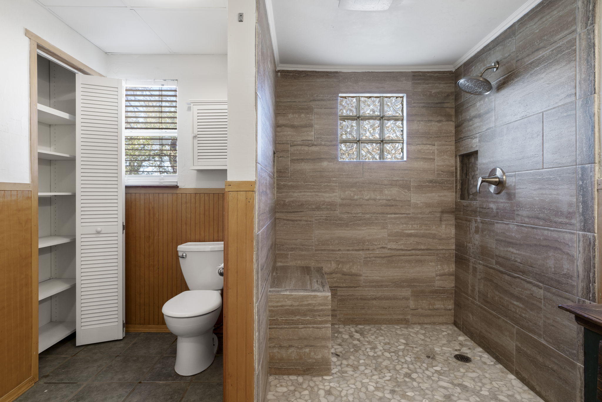2058 Montell Road Wimberley, TX 78676 - Photo 17 of 35 a bathroom with a toilet a window and shower