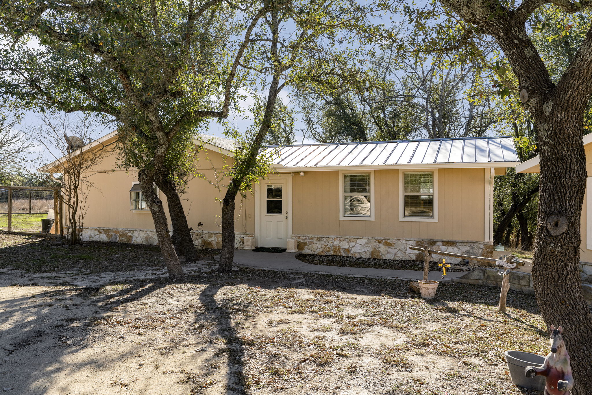 2058 Montell Road Wimberley, TX 78676 - Photo 2 of 35 a front view of a house with a yard