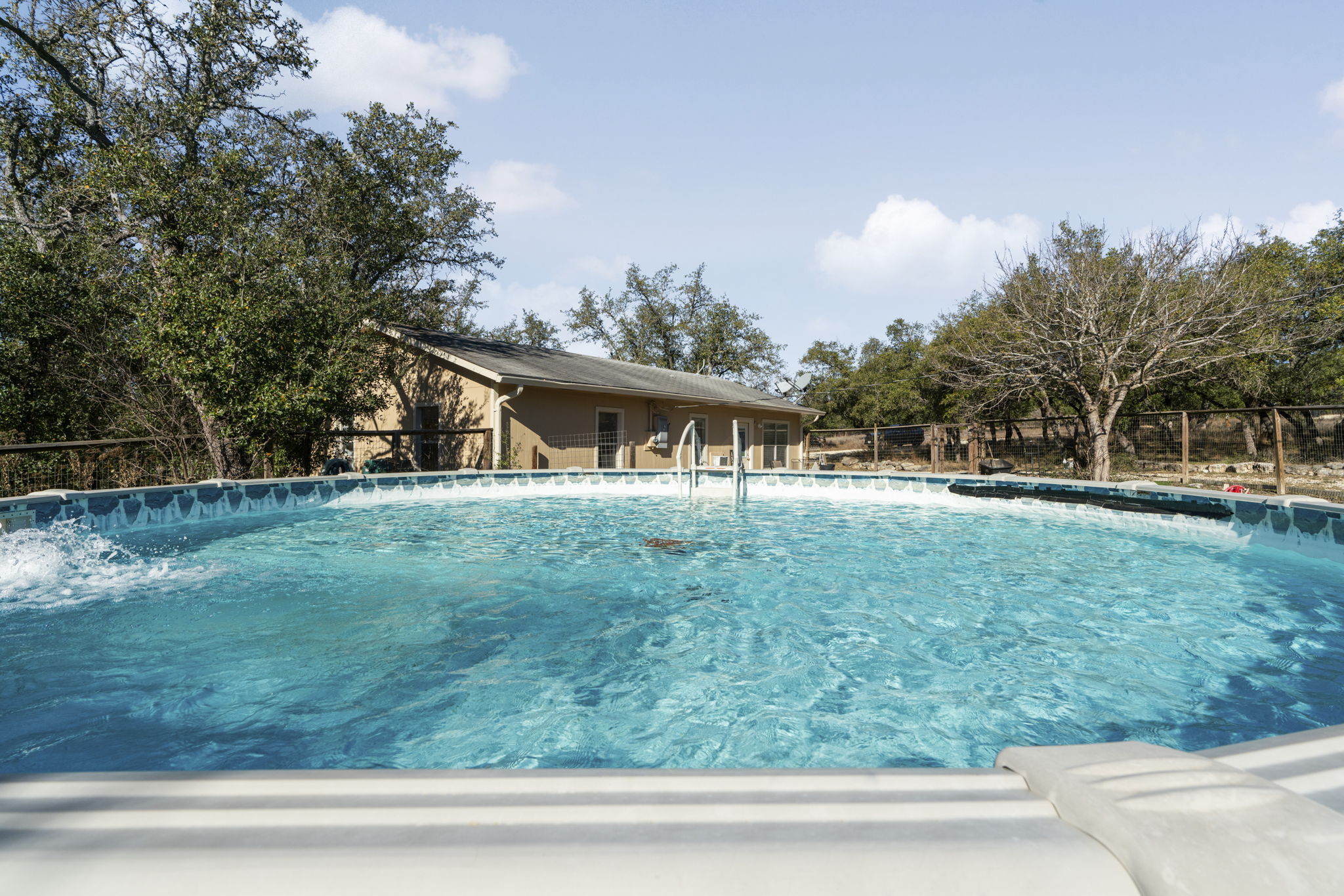 2058 Montell Road Wimberley, TX 78676 - Photo 26 of 35 a view of a house with a backyard