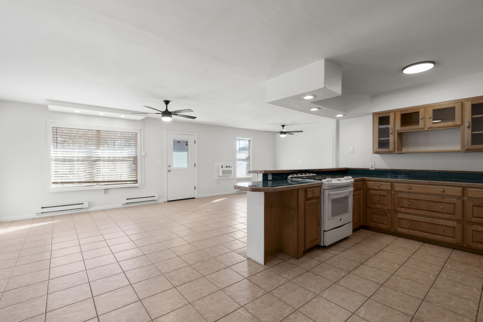 2058 Montell Road Wimberley, TX 78676 - Photo 3 of 35 a large white kitchen with a stove top oven and cabinets